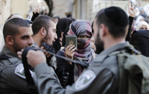 A Palestinian woman protests being blocked from entering the Al-Aqsa mosque in Jerusalem. During the weeklong Jewish celebration of Sukkot, Jews have been given access to the compound. Image by Ahmad Gharabli/AFP