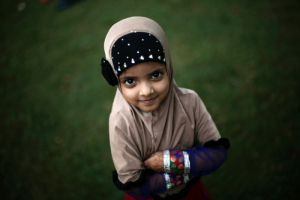 Indian girl poses, as she attends the Eid prayers in Delhi, India. Image by Adnan Abidi/Reuters