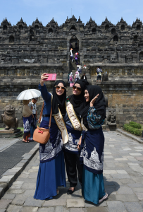 Finalists of the World Muslimah Competition pose for a selfie in front of the Borobudur temple on Java, Indonesia. Image by Adek Berry/AFP
