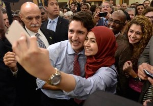 Justin Trudeau takes a selfie with a woman in a headscarf. [Source].